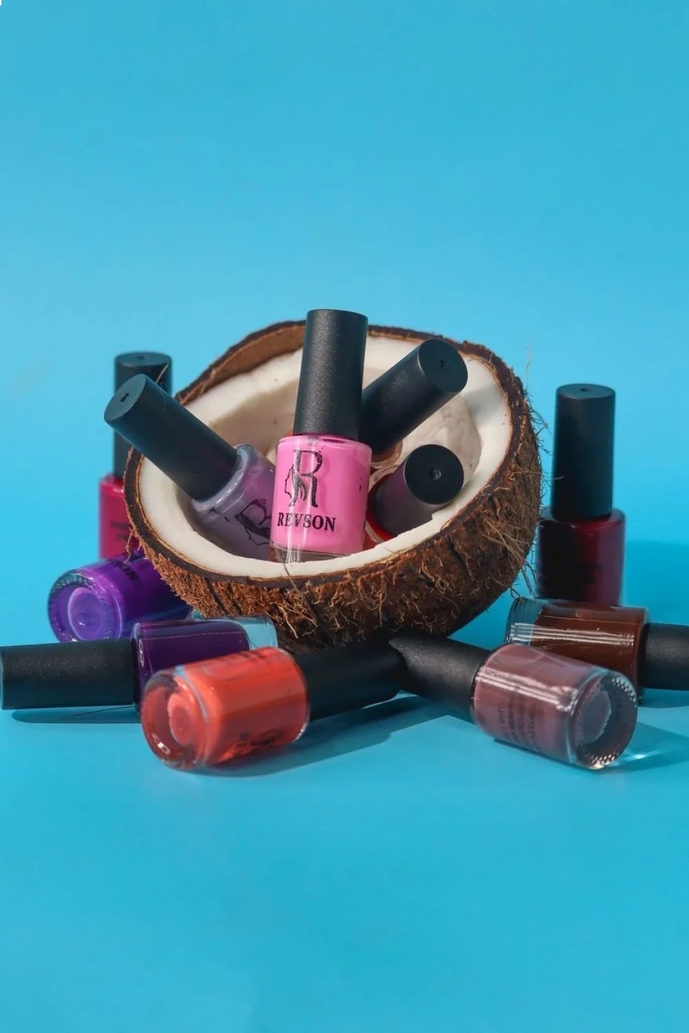 15 nail polish bottles in coral to turquoise gradient with applicator brushes arranged around a coconut...
![15 nail polish bottles in coral to turquoise gradient with applicator brushes arranged around a coconut shell